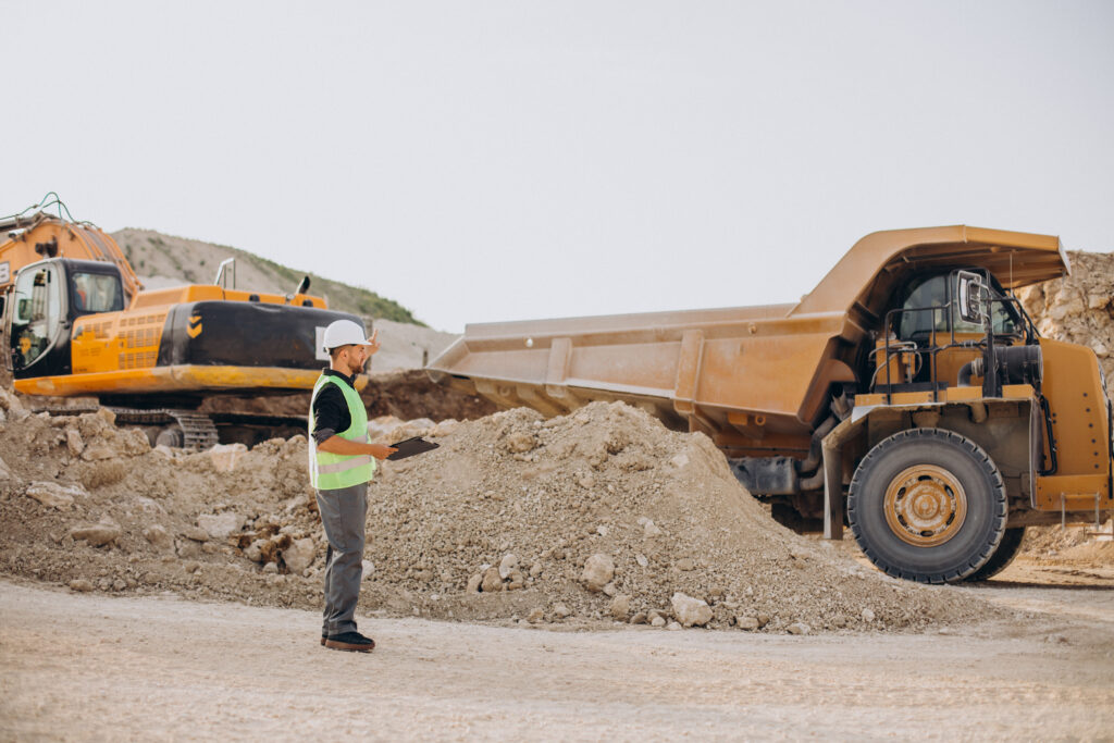 Imagen excavacion con camion escavadora y obrero